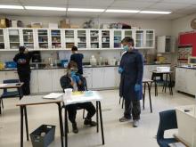 Maria Niño-Soto observes her socially distanced students working in the lab.